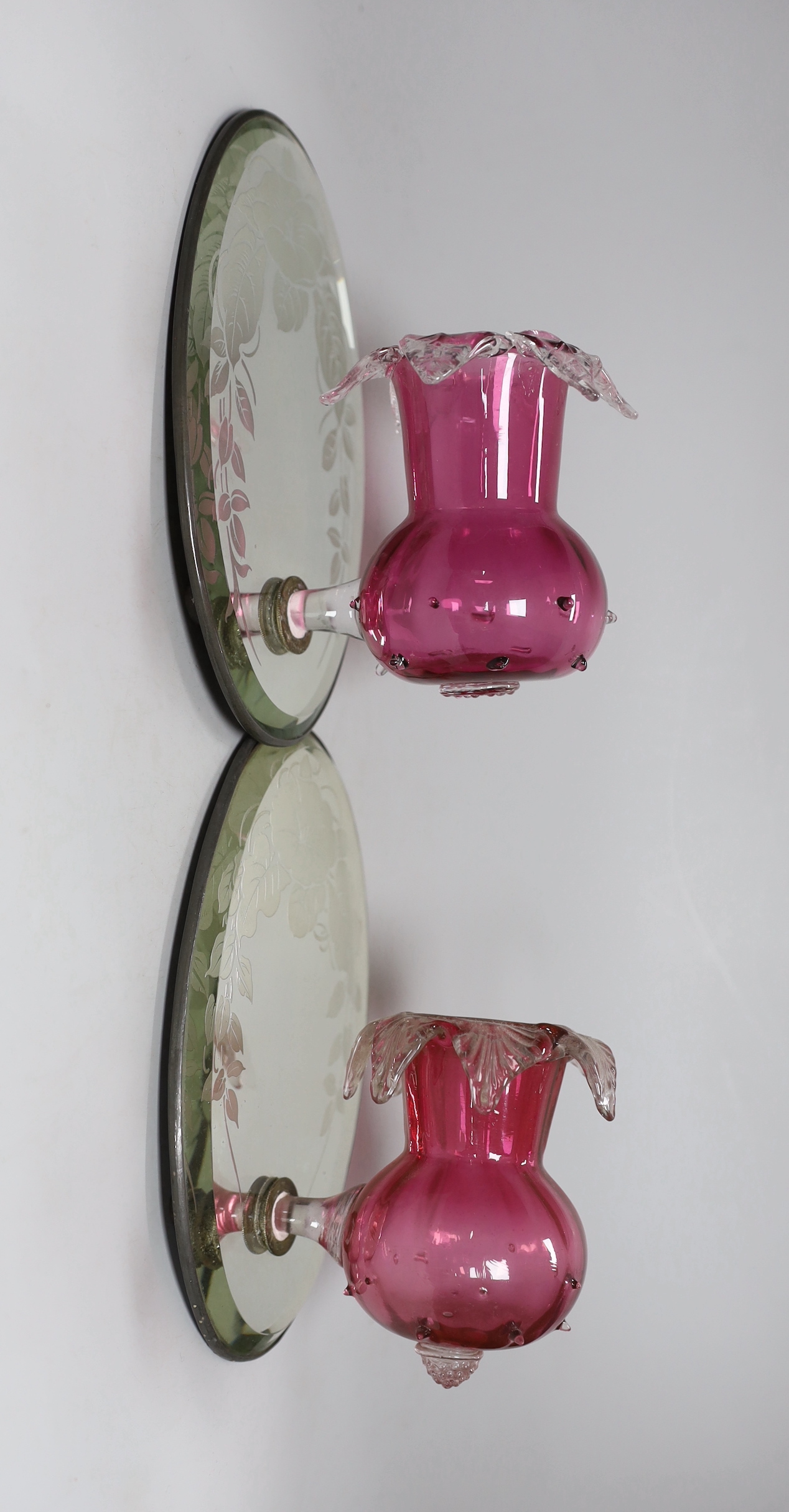 A pair of Victorian style cranberry glass wall lights with oval mirror back plates